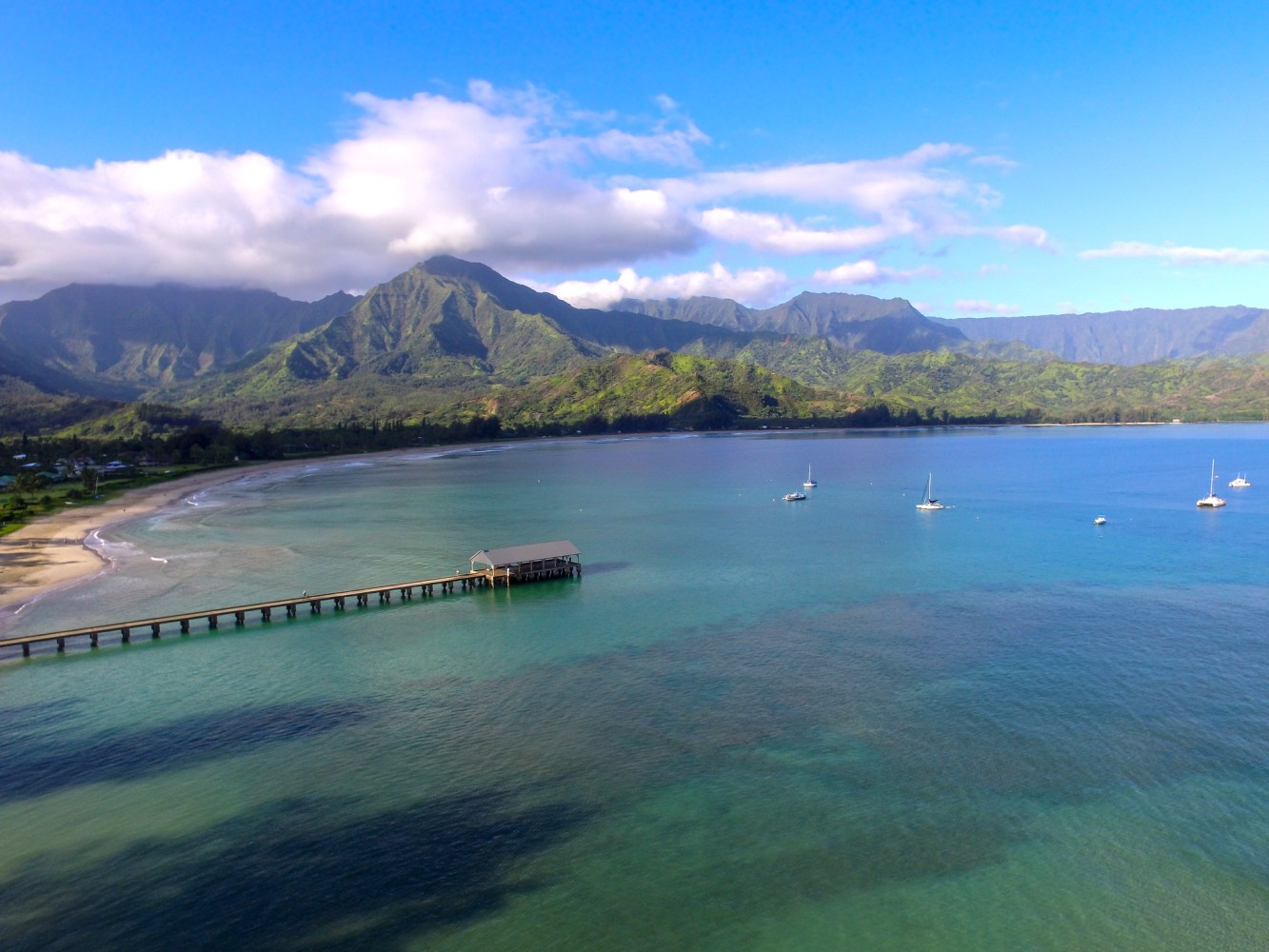 a large body of water with a mountain in the background